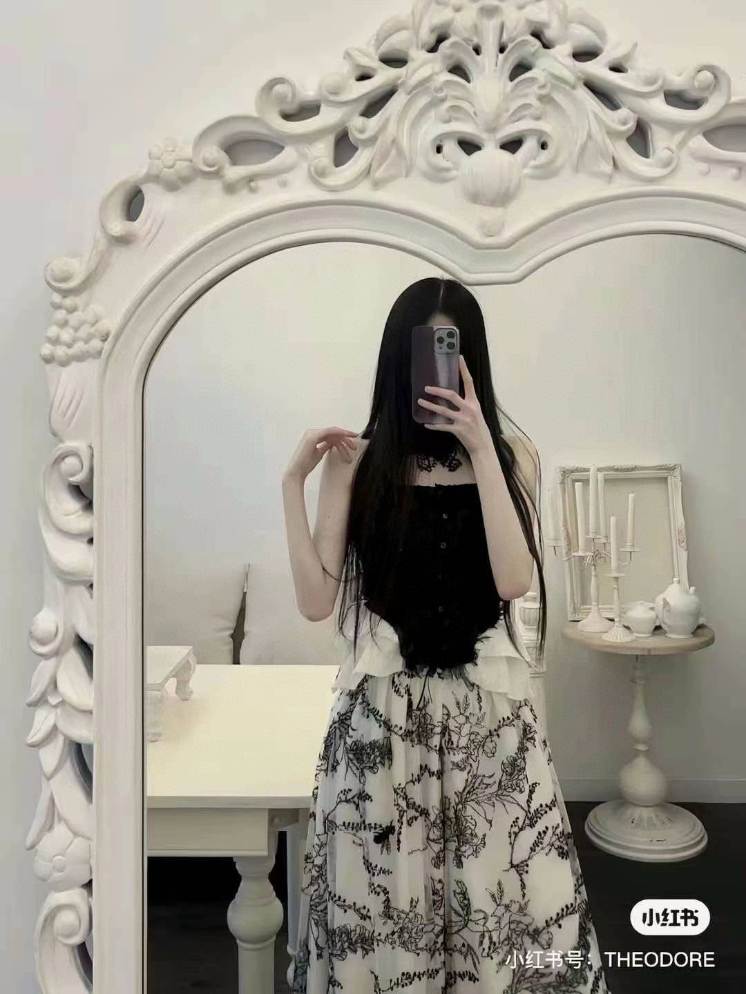 Black camisole top and printed skirt-pants set.
