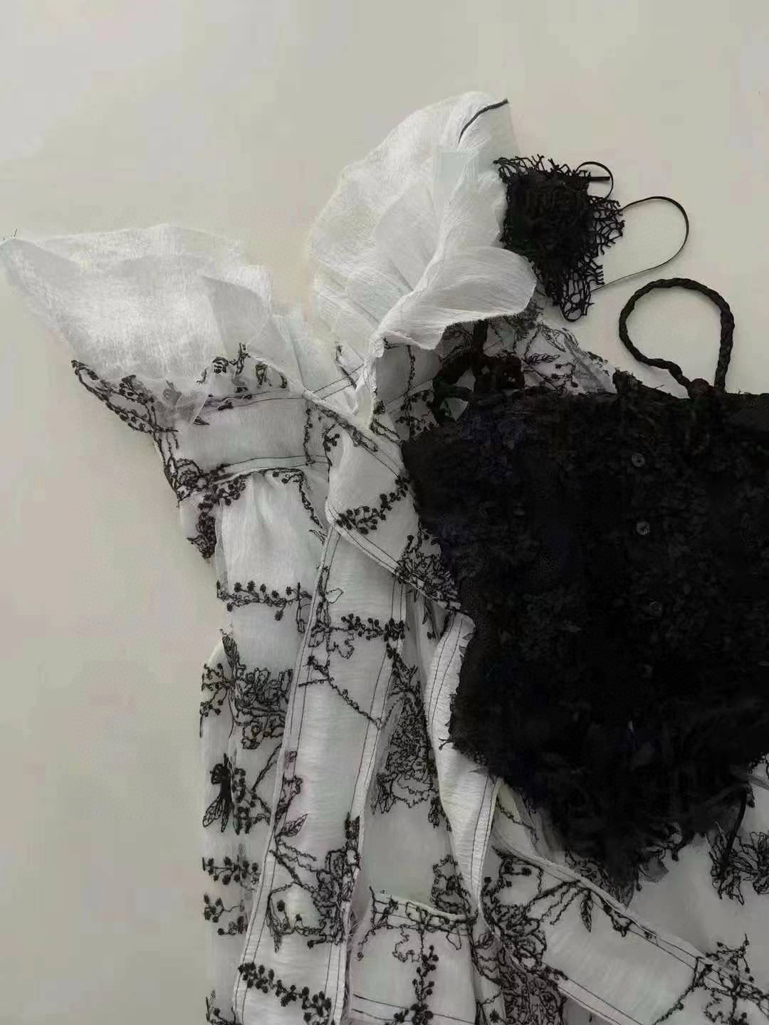 Black camisole top and printed skirt-pants set.